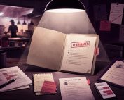 Restaurant termination file under spotlight with staffing schedule, complaint form, notes, and text messages on a desk.